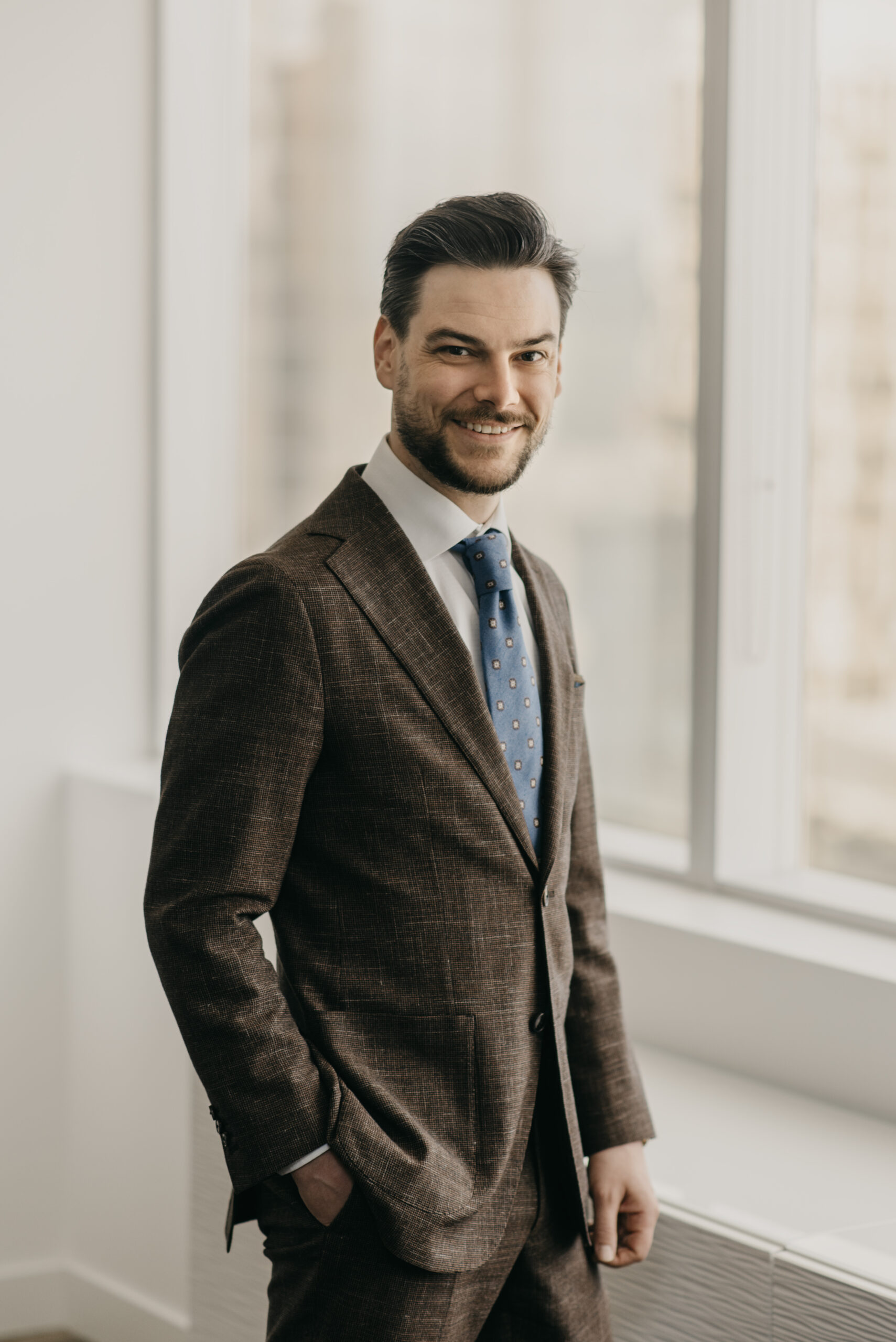James Hawkins, Calgary criminal defence lawyer, standing confidently in his law office